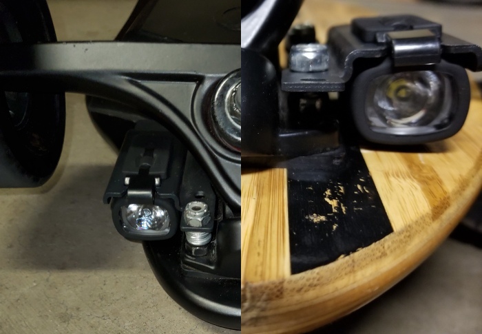 Head on view ShredLights SL-200 mounted almost flush underneath a longboard deck - in this case, the USB side is facing up